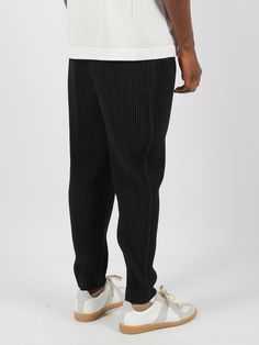 HOMME PLISSE` ISSEY MIYAKE Mc August trousers, in pleated fabric. - FW24 - Regular and straight fit - Tapered model - Elasticated waist with internal drawstring - Belt loops - Internal drawstring - Side welt pockets - Made in Philippines - 100% Polyester Modern Pleated Bottoms For Spring, Casual Bottoms With Accordion Pleats, Black Pleated Tapered Leg Pants, Casual Fitted Pleated Pants, Black Relaxed Fit Pleated Bottoms, Black Casual Pleated Pants, Casual Black Pleated Pants, Casual Fitted Pants With Pleated Waist, Casual Black Bottoms With Pleated Waist