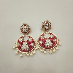 Elegant gold foil Coral & Lotus Kundan Chandbali earrings featuring pearl drops. The lotus kundans add a touch of serenity, while the coral accents bring warmth and vibrancy. Perfect for adding a traditional charm to any look. Length: 3" to 3.5" Material: 24Kt gold foil, lac Stones: Kundans, semi precious corals, semi precious pearls