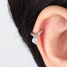 A true eye-catching dazzler, this sparkling round drop hoop is ideal to wear alone or matching with our studs, hoops for a cohesive look. With a flesh set of cubic zirconia sparkling gems, it is the touch of luxury you've been looking for to add to your everyday look! Detail： -Material: stainless steel -Used in healed piercings. -Tarnish proof and durable so you can wear it everyday without worry! Quantity & Measurement：-Gauge: 20g-Diameter: 5mm | 0.20"-Include: 1*Cozy-Comfortable to wear, hypoa Single Cubic Zirconia Hoop Cartilage Earring, Single Cubic Zirconia Cartilage Hoop Earring, Cubic Zirconia Dangle Ear Cuff, Anniversary Piercings In Diamond White Cubic Zirconia, Cubic Zirconia Round Ear Cuff, Silver Cubic Zirconia Piercings With Sparkling Stones, Silver Hoop Cartilage Earrings Cubic Zirconia, Silver Cubic Zirconia Huggie Ear Cuff, Dazzling Cubic Zirconia Hoop Earrings With Rhinestones