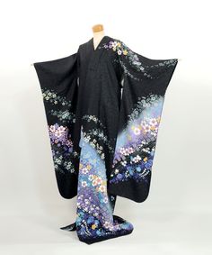 This furisode kimono is a stunning piece made entirely of 100% silk.  The black fabric is woven with shimmering gold threads, adding an elegant sparkle reminiscent of a starry night sky.  The soft blue gradient dyeing adds a gentle touch to the overall design.  This kimono is beautifully adorned with a variety of floral patterns created through traditional yuzen dyeing techniques. There are no noticeable stains, and it is still in a wearable condition.  Whether you choose to wear it or display i Black Silk Dress With Kimono Sleeves, Traditional Black Kimono With Floral Print, Traditional Black Floral Print Kimono, Black Fitted Long Kimono, Fitted Long Black Kimono, Vintage Black Kimono For Spring, Black Silk Kimono For Spring, Traditional Black Dress With Kimono Sleeves, Traditional Fitted Black Kimono