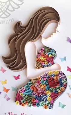 a paper cut out of a pregnant woman holding her stomach with butterflies flying around it