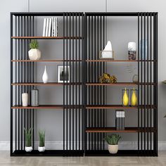 a book shelf filled with lots of books on top of a hard wood floor next to a white wall