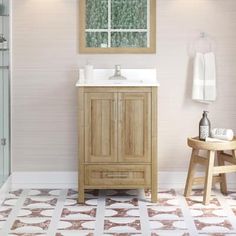 a bathroom with a sink, mirror and wooden cabinet in it's center area