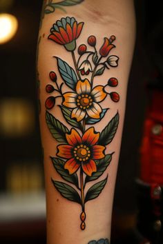 a woman's arm with flowers and leaves tattooed on the side of her leg