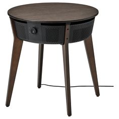 a round table with two legs and a speaker on the top, in front of a white background