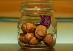 a glass jar filled with nuts on top of a table