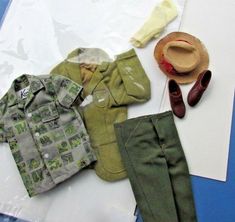 an assortment of children's clothing and accessories laid out on top of a piece of paper