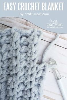 the crochet blanket is laying on top of a wooden table with text overlay that says easy crochet blanket