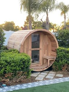 a wooden sauna in the middle of some bushes