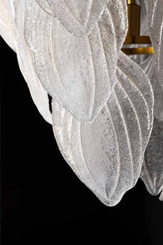 a chandelier with frosted leaves hanging from it's sides