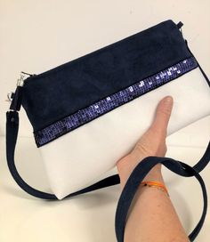 "Navy blue and white shoulder bag with matching sequins, in suedette with a very velvety feel, suede effect. The zippered pocket is decorated with navy blue sequins on both sides. Of beautiful dimensions, this shoulder bag will easily contain your essentials, keys, papers, phone, ... etc. Height: 18 cm, length at the base 31 cm, length of the zip 25 cm, thickness 6 cm. By its design, it has a very nice hold, even empty!  It is fully lined inside with a coordinated printed cotton fabric. (Warning: the fabrics I use for the inside lining may vary but are always perfectly matched with the style and colors of the article) A large coordinated suedette tassel adorns the zipper slider. A removable shoulder strap (2 silvered and riveted snap hooks) in suedette will allow you to carry it on your sh White Evening Bag With Zipper Closure, White Shoulder Bag With Zipper Closure For Evening, White Party Bags With Zipper Closure, White Party Clutch Crossbody, Navy Blue Decor, White Shoulder Bag, Printed Cotton Fabric, Suede Tassel, Vanessa Bruno