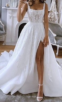 a woman is taking a selfie in her wedding dress while sitting on the floor