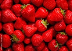 a large group of strawberries are shown in this close up photo, with the top half