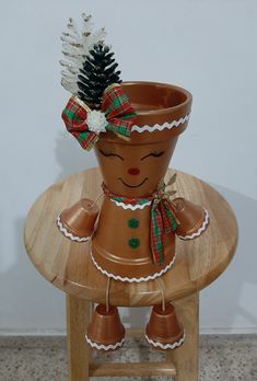 a potted plant sitting on top of a wooden table next to a small pine cone