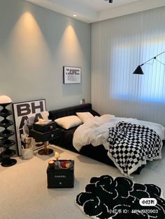 a bed room with a neatly made bed and black and white decor on the walls