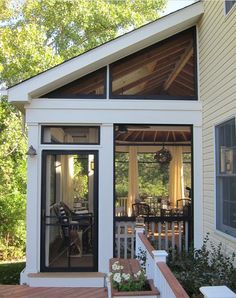 a small white house with an open porch