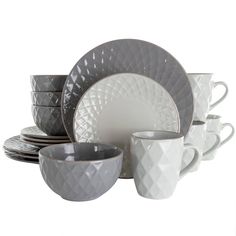 a white and grey dinnerware set on a white background