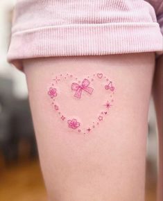 a woman's thigh with hearts and bows on her thighs, all in pink