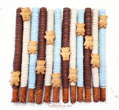 there are many cookies and candy sticks with teddy bears on them in the shape of animals