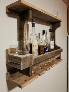 a wooden shelf with bottles and glasses on it