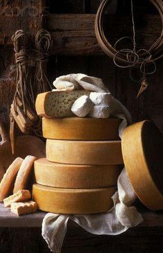 a pile of cheese sitting on top of a wooden table