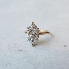 a three stone diamond ring on a white surface