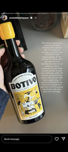 a person is holding a bottle of bottivro