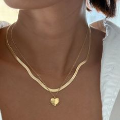 This necklace features a charming heart pendant inscribed with the word "Love" in delicate cursive script. The chubby heart design adds a playful and romantic touch, perfect for everyday wear or as a meaningful gift. 14k Gold Filled Chain 24k Gold Filled Heart Charm Charm size: 11.9mm x 11.7mm Chain length: 16" and 18" Lobster clasp closure Hypoallergenic Water resistant & tarnish free Nickel & lead free Trendy Gold Heart Charm Necklaces, Trendy Gold Heart Charm Necklace, Trendy Gold Charm Necklaces For Valentine's Day, Trendy Gold Heart Necklace For Everyday, Trendy Yellow Gold Heart Necklace, Trendy Double Heart Necklace For Valentine's Day, Everyday Double Heart Tarnish Resistant Necklace, Trendy Heart Pendant Necklace For Anniversary, Trendy Open Heart Necklace As A Gift