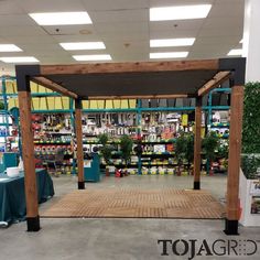 the inside of a store with tables and shelves full of goods for sale on display