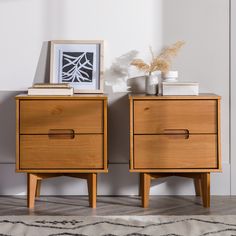 two wooden nightstands sitting next to each other on top of a carpeted floor