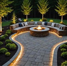 an outdoor fire pit surrounded by landscaping lights