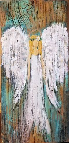 an angel painted on wood with white wings