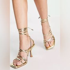 New Beautiful Hiccup Strappy Tie Leg Mid Heeled Sandals In Gold Gold Lace-up Sandals With Heel Strap For Summer, Gold Strappy Lace-up Sandals, Trendy Gold Sandals With Wrapped Heel, Gold Strappy Heels For Summer, Gold Sandals For Summer Night Out, Gold Lace-up Sandals With Heel Strap For Party, Trendy Gold Strappy Sandals, Gold Sandals For Night Out In Summer, Gold Lace-up Open Heel Sandals For Party