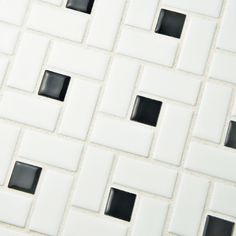 a white and black tile with squares on it's sides is seen in this image