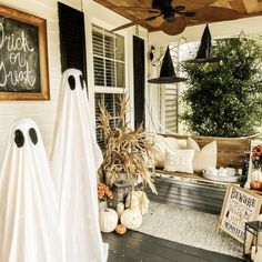 Front porch halloween decorations: ghosts, pumpkins, witch hats hanging from the ceiling Ghost Chair Halloween, Ghost Porch Decoration, Halloween Porch Themes, Witch Hat Porch Decor, Floating Witch Hats Porch, Hanging Witch Hats Porch, Farmhouse Halloween Decor Porch, Hanging Ghosts Diy, House Party Themes