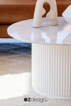 a white table sitting on top of a carpeted floor