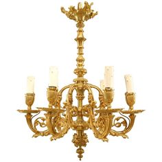 an antique chandelier with six candles on it