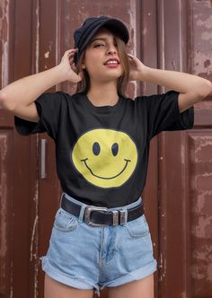 Smiley face shirt. So soft, so lightweight, so comfortable, so chic! This is a unisex fit. Size up for an oversized look or stay true to size for a classic fit. * 100% combed and ring-spun cotton  This product is made to order just for you! Please allow 2-7 business days for processing plus shipping time. Cheap Fun Smiley Face T-shirt, Fun Crew Neck T-shirt With Funny Print, Cute Black Short Sleeve T-shirt, Cute Black T-shirt With Screen Print, Cute Black Crew Neck T-shirt, Fun Cotton T-shirt With Smiley Face, Cute Pre-shrunk Black T-shirt, Cute Black Pre-shrunk T-shirt, Fun Black T-shirt