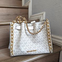 Nwt Michael Kors Mina Small Belted Chain Shoulder Crossbody Bag Mk Light Cream Crossbody Bag Logo-Print Canvas 89.4% Coated Canvas/9.6% Polyester/1% Polyurethane Trim 1: 52% Polyurethane/48% Polyester Trim 2: 60% Polyurethane/20% Cotton/20% Polyester Gold-Tone Hardware 8.25"W X 6.75"H X 3.5"D Interior Details: 3 Back Card Slots Lining: 100% Polyester Snap Fastening Imported White Crossbody Shoulder Bag With Metal Logo, Chic White Shoulder Bag With Metal Logo, White Rectangular Bag With Metal Logo, Chic White Bag With Metal Logo, Michael Kors White Shoulder Bag With Chain Strap, Light Cream Color, Orange Handbag, Bag Logo, Luxurious Fashion