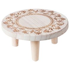 a wooden stool with an intricate design on it