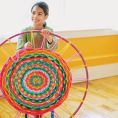 a young boy is playing with a colorful toy