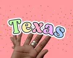 a person's hand with the word texas on it