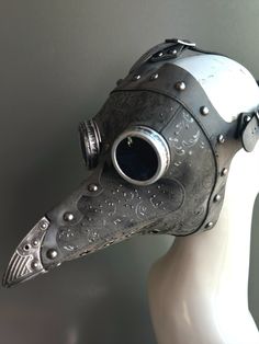 This black steampunk plague mask features striking red filigree details, riveted accents, and vintage-style goggles. Perfect for Halloween, masquerades, or steampunk-themed events, the intricate design blends gothic and industrial aesthetics, making it a standout costume accessory. The bold black finish with red embellishments ensures you'll capture attention at any event. Ideal for those seeking a dark and mysterious look. Age Group/Gender - Adult/Unisex Size/Type - One size fits all adults Mas Plague Costume, Plague Doctor Hat, Plague Doctor Halloween Costume, Steampunk Masquerade, Kids Party Packs, Black Steampunk, Plague Mask, Bird Mask, Dark And Mysterious