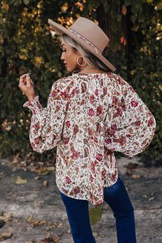 Your fall style is sure to blossom with our 'Style Statement' top! Features a lightweight chiffon material with a floral print, accent golden polka dots, a buttoned up with a round neckline, long loose sleeves with smocked cuffs, an attached spaghetti tank top, and a relaxed flattering silhouette that ends in a straight hemline. Measurements S : Bust 36", Hip 42", Length 23", Sleeve Length 26.5", Waist 40". M : Bust 38", Hip 44", Length 23.5", Sleeve Length 27", Waist 42". L : Bust 40", Hip 46", Chic Floral Print Long Sleeve Peasant Top, Bohemian V-neck Peasant Top With Floral Print, Bohemian Blouse With 3/4 Sleeve Floral Print, Bohemian Floral Print Top With 3/4 Sleeves, Multicolor Floral Print Non-stretch Top, Chiffon Material, Loose Sleeves, Floral Top, Model Fits