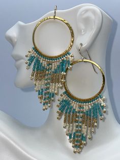 boho hammered gold hoop earrings featuring pearlescent cream, aqua and metallic gold seed beads.  Handmade in a boho tribal pattern. Seed Bead Hoop Earrings, Concert Date, Aqua And Gold, Bead Hoop Earrings, Beading Thread, Boho Patterns, Earrings In Gold, Beaded Hoop Earrings, Fun In The Sun