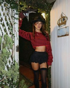 a woman in black and red striped shirt holding an umbrella