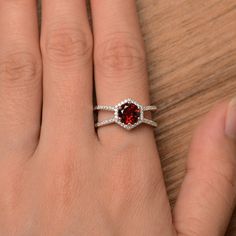 It is a natural garnet ring. The main stone is 7mm*7mm round cut, weight about 1.68 carats. The basic metal is sterling silver and plated with rhodium. To change the metal to a solid gold (white/rose) or platinum is also available, please ask for a quotation if you want. You can also go to my shop Home for more elegant rings: https://www.etsy.com/shop/godjewelry?ref=hdr_shop_menu More natural garnet rings: https://www.etsy.com/shop/godjewelry?ref=seller-platform-mcnav&section_id=20709242 Cus Red Ruby Halo Ring For Promise, Red Ruby Halo Promise Ring, Round Cut Garnet Jewelry For Anniversary, Wedding Jewelry With Halo And Lab-created Ruby, Gift Ruby Ring With Halo, Burgundy Ruby Round Rings, Red Round Cut Halo Ring, Red Halo Jewelry For Anniversary, Silver Ruby Ring With Halo Design