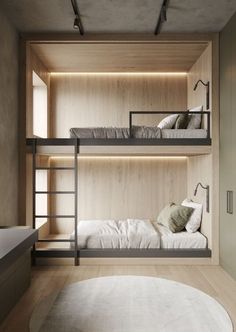 two bunk beds are in the middle of a room with wooden walls and flooring