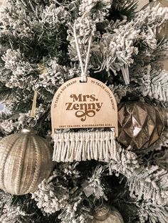 a christmas tree with ornaments hanging from it's branches and an ornament