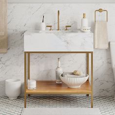 a bathroom with white marble and gold fixtures